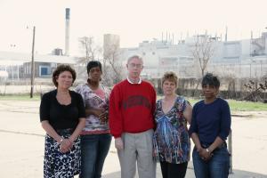 former factory employees posed outside of warehouse in Wisconsin