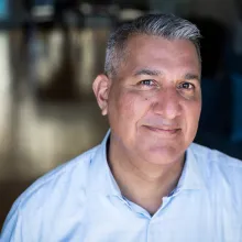 Richard Ray Perez is a middle-aged male with medium skin tone, short greying hair, wearing a light blue shirt.